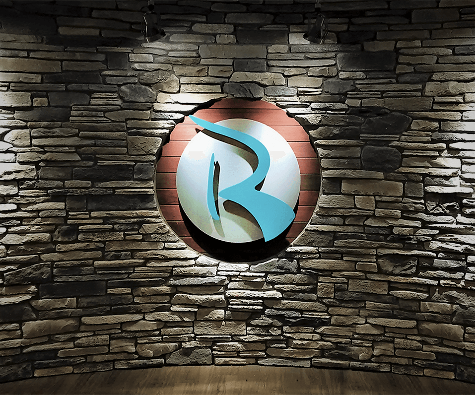 Interior Logo for Rejuve on stacked stone wall with wood accent